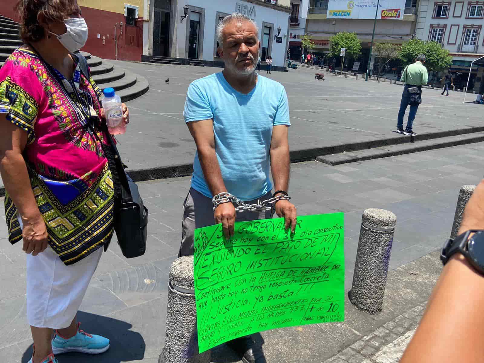 Encadenado, docente mantiene huelga de hambre en centro de Xalapa